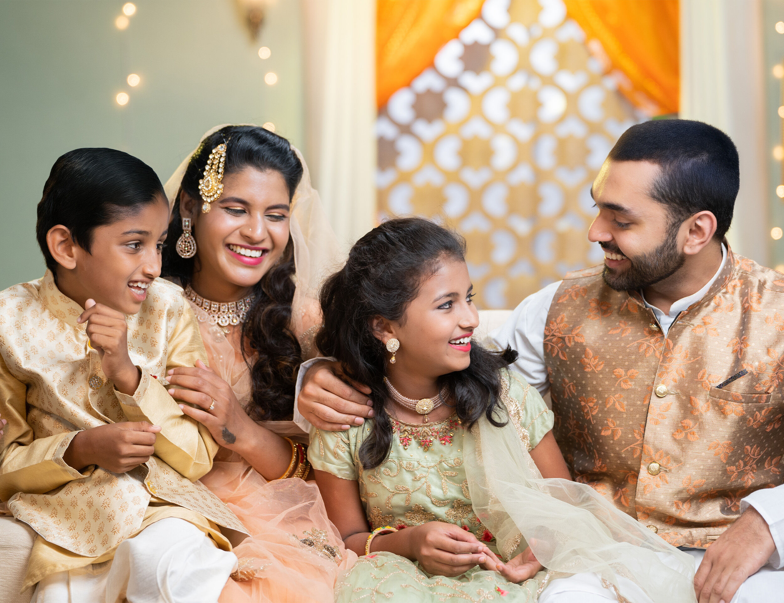 Happy family dressed in traditional attire celebrating Eid with joy and laughter